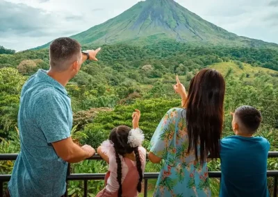 Family pointing at Arenal Volcano during a Find My Costa Rica nature experience.