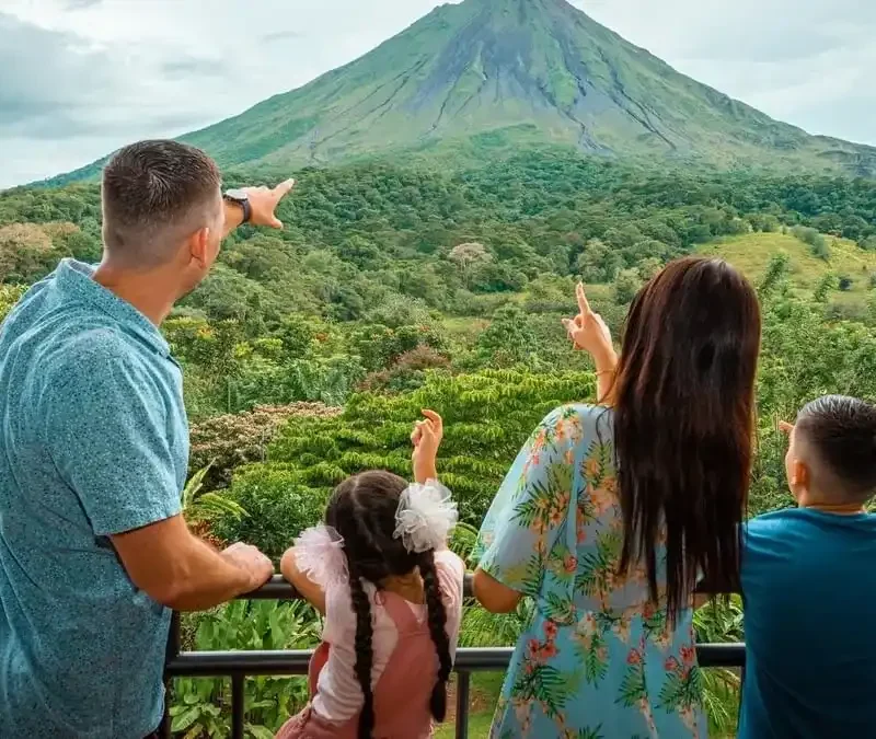 Family pointing at Arenal Volcano during a Find My Costa Rica nature experience.