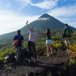 Group of hikers exploring the lava trails of Arenal Volcano in Costa Rica