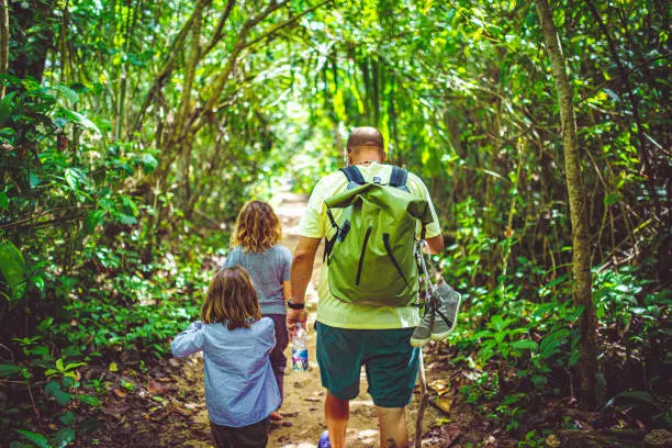 Father and two daughters hike in Costa Rica Hanging bridges Costa Rica