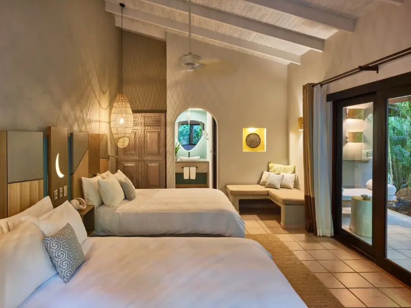 boutique-hotel-room-tamarindo-costa-rica.png elegant boutique hotel room with double beds and garden view in tamarindo costa rica