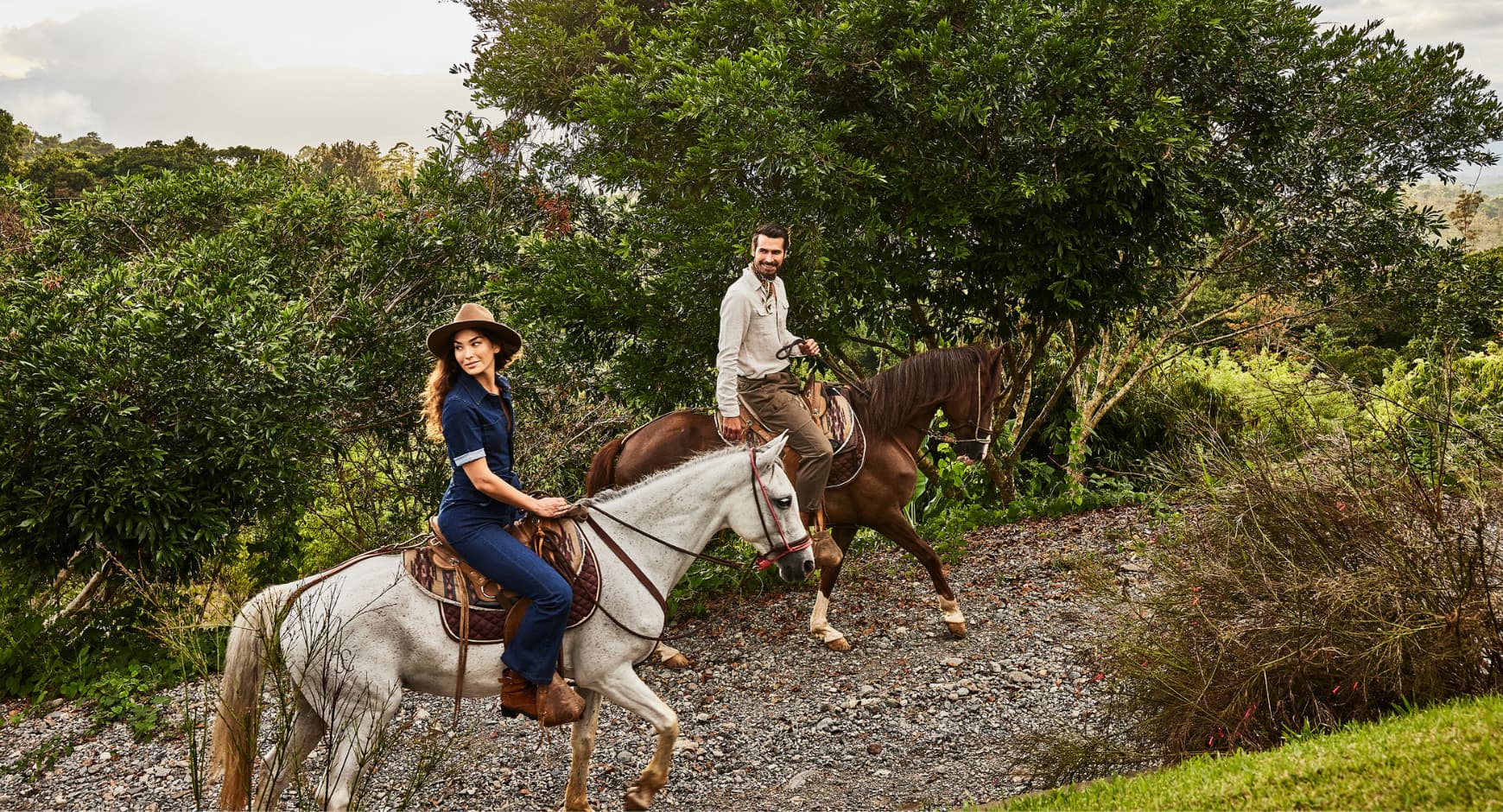 Couple horseback riding through the lush hills of Pérez Zeledón, Costa Rica.