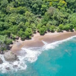 Aerial view of a remote beach surrounded by lush jungle on Costa Rica’s Osa Peninsula, Pacific Coast.