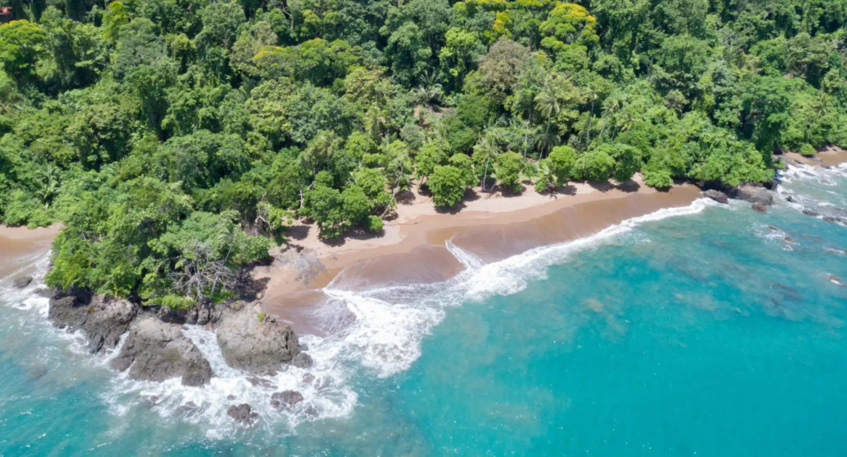 Aerial view of a remote beach surrounded by lush jungle on Costa Rica’s Osa Peninsula, Pacific Coast.