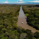 Aerial view of river boat tour through Costa Rica’s tropical wetlands