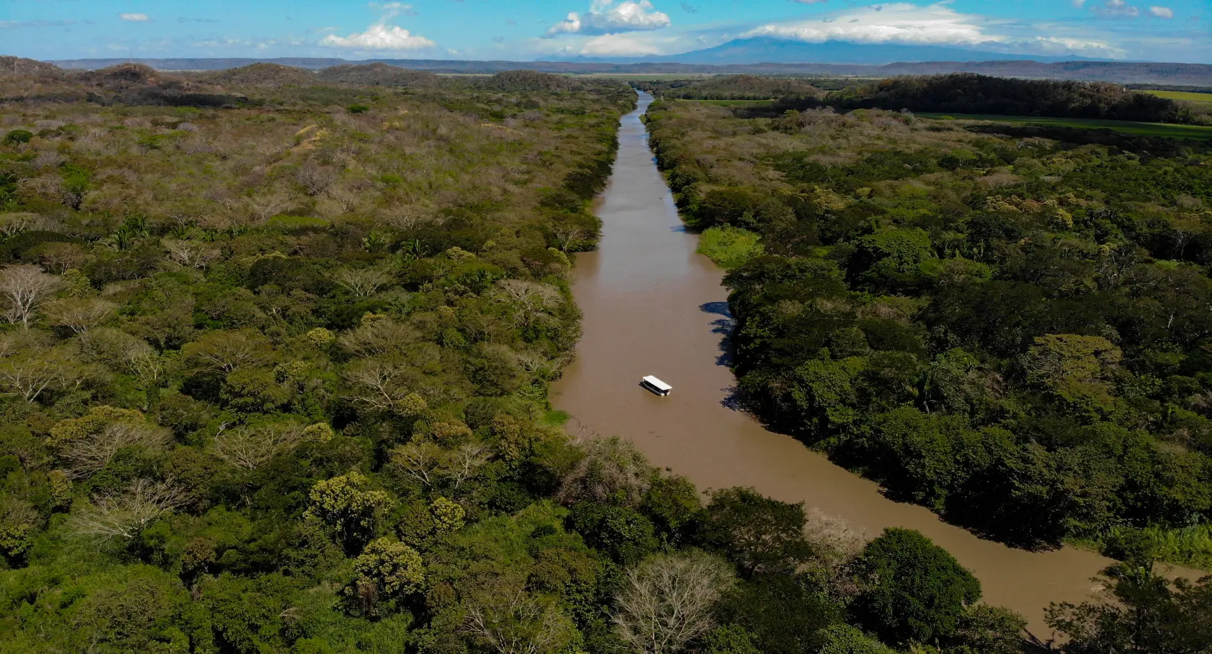 Aerial view of river boat tour through Costa Rica’s tropical wetlands