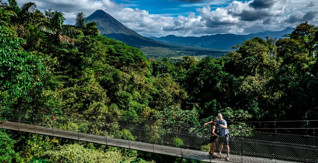 Aerial view of travelers crossing the Arenal hanging bridges surrounded by rainforest